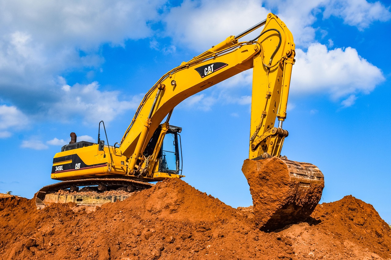 Koparko-ładowarka JCB 4CX PRO w trakcie wykopu na polu